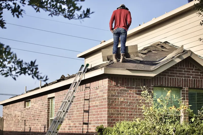 Professional roofer working on a residential roof in Dove Tree